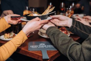 food tour guests passing a dish to each other